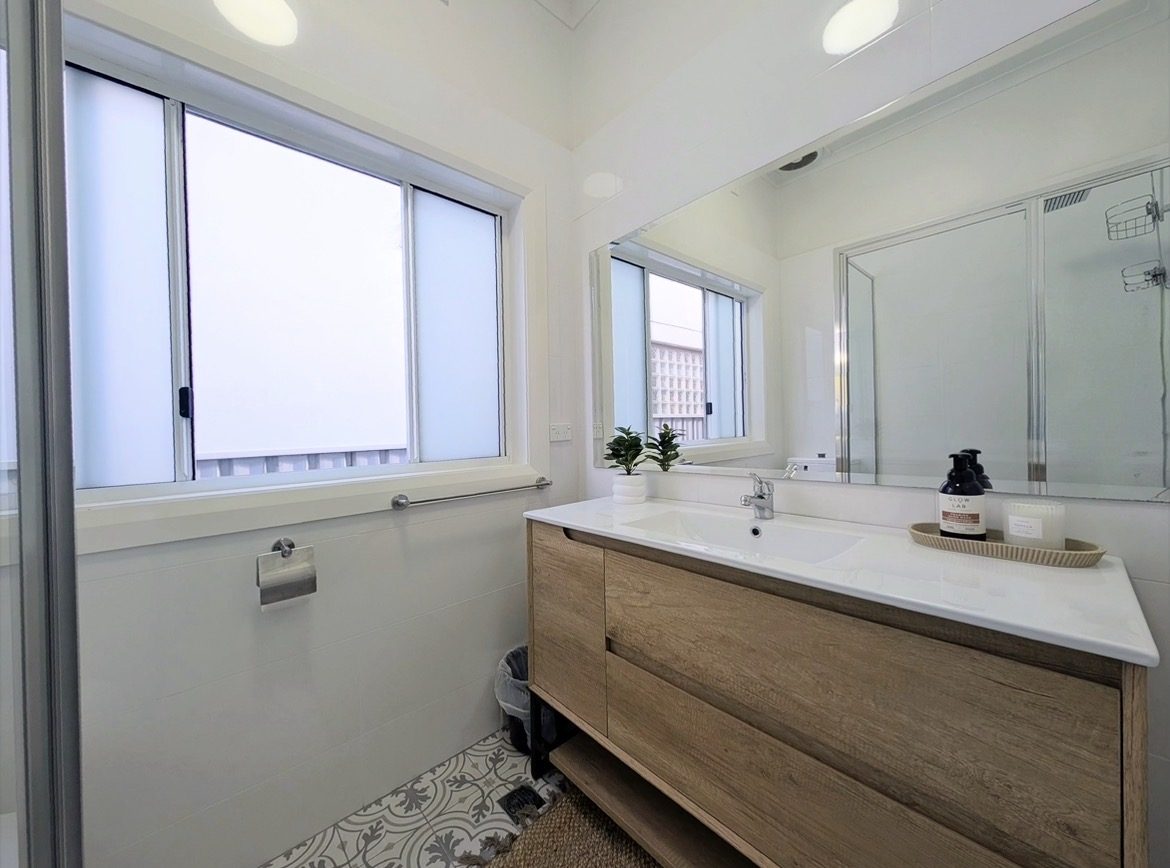 Main bathroom with vanity and walk-in shower