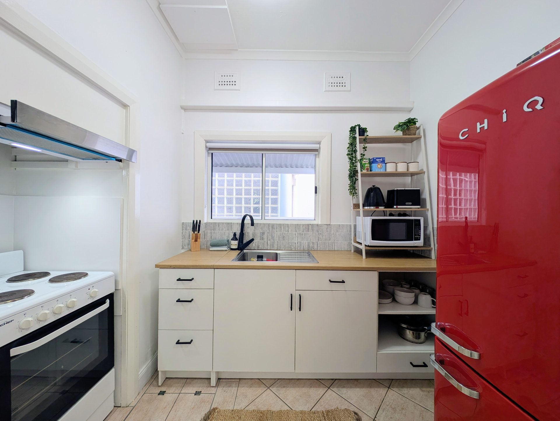 Kitchen with oven, microwave and full-size fridge
