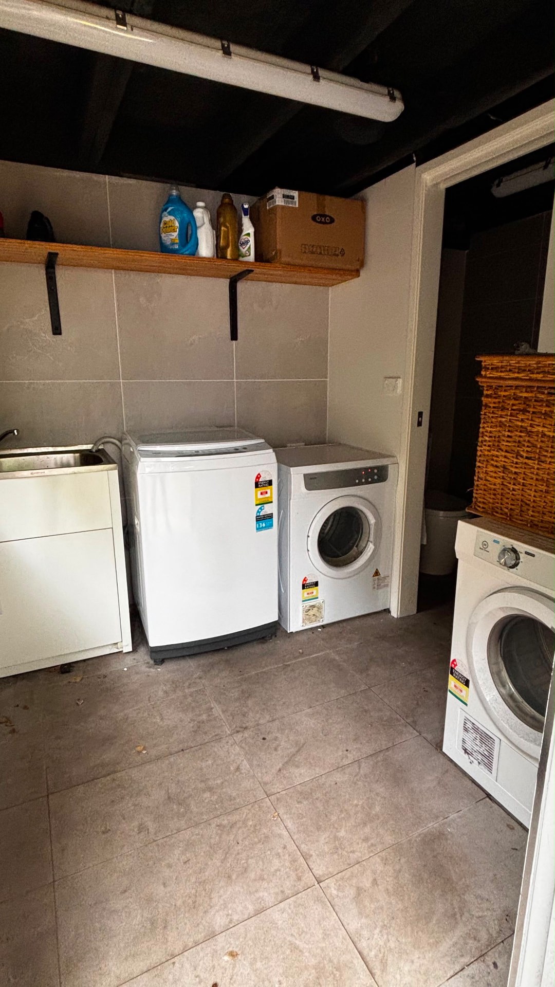 Laundry room with washing machines, dryer and sink